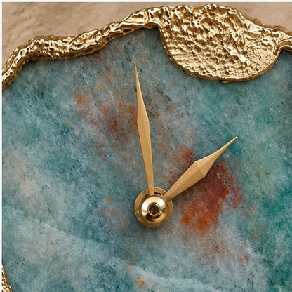 Close-up of the gold hands, the rust red patch and the textured gold corner