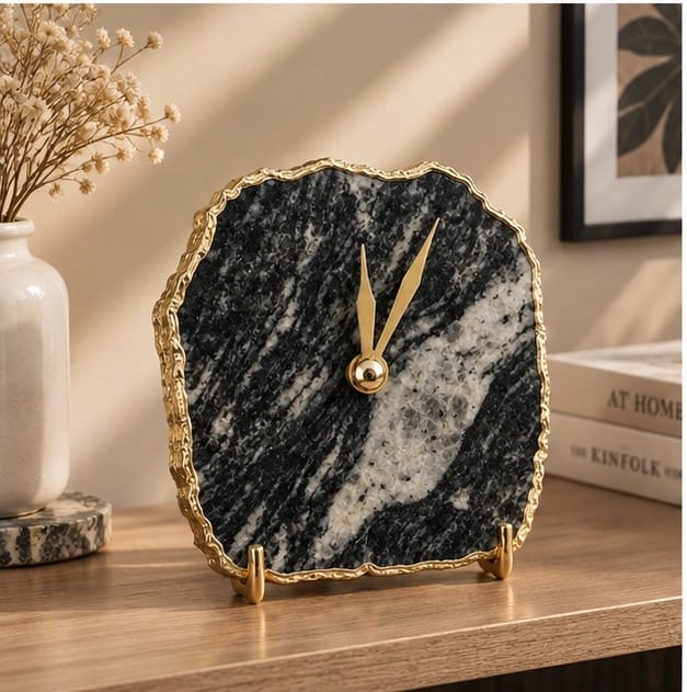 Zebra agate desk clock on a wooden shelf with books and dried flowers