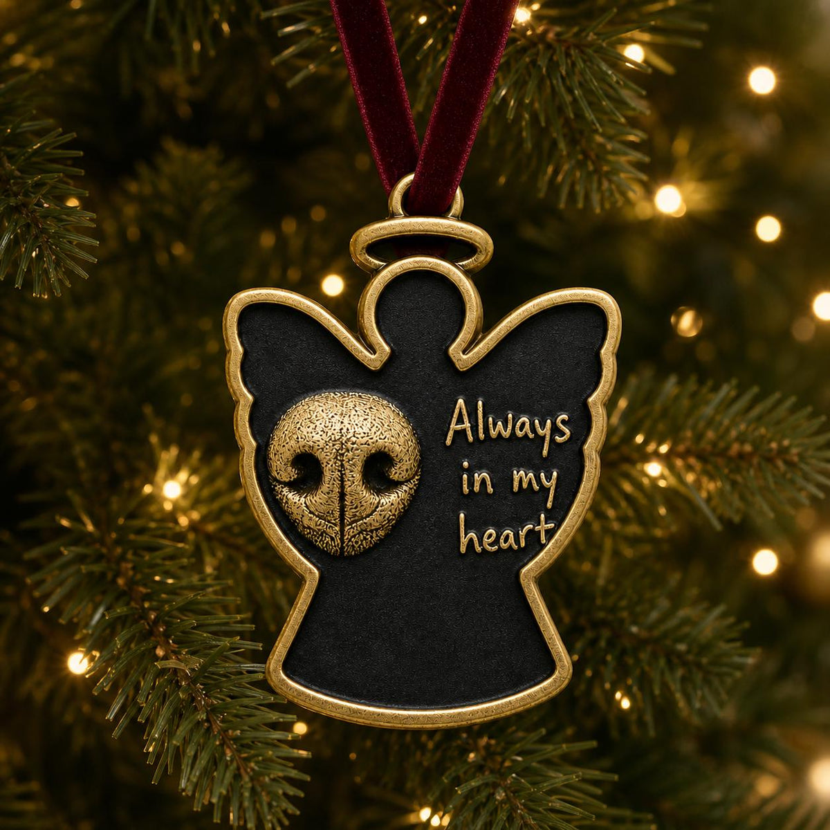 Angel nose print ornament hanging on a lit Christmas tree