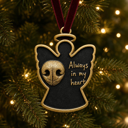 Angel nose print ornament hanging on a lit Christmas tree