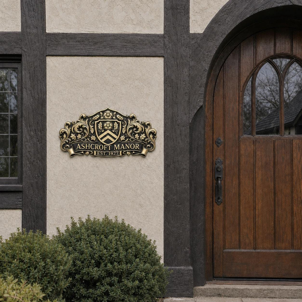 Wide house name plaque on a stucco wall with dark timber beside an arched wooden door