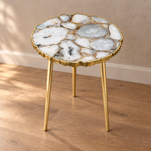 
White Crystal Agate Side Table, Organic Edge with a gold rim and three plain gold legs, shown full length in a room