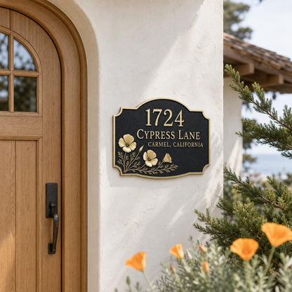 Poppy plaque on a white stucco wall beside an arched wooden door