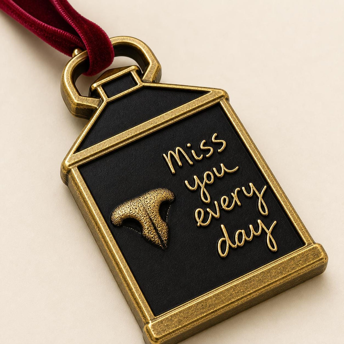 Close angled view of the lantern ornament with the raised nose print and script lettering