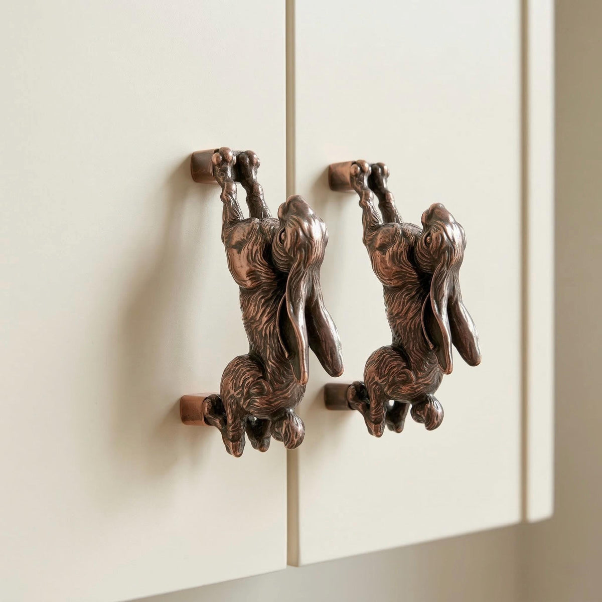 Hopping hare handles in antique copper on cabinet doors