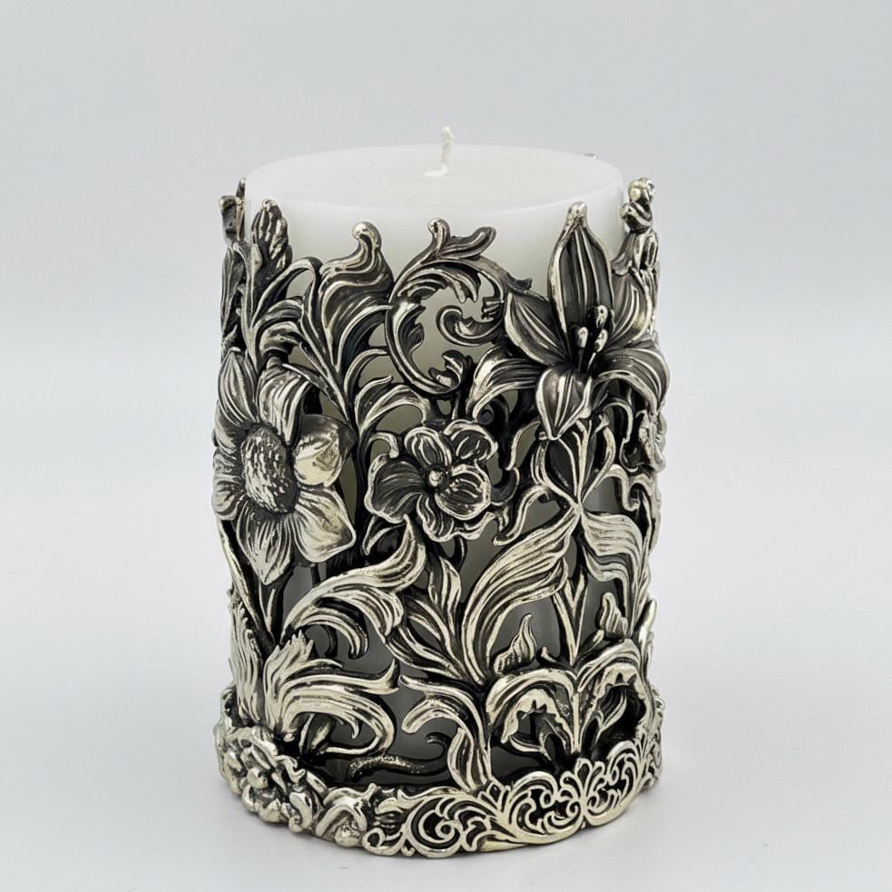 Side view of the floral pillar candle holder with a lily and smaller flowers in relief