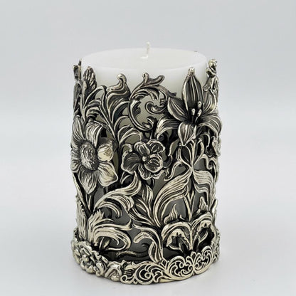 Side view of the floral pillar candle holder with a lily and smaller flowers in relief