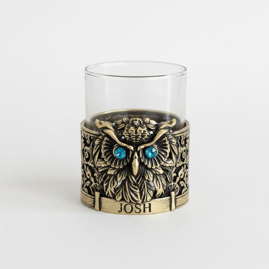 Gemstone owl whiskey glass in antique brass with blue stone eyes and JOSH on the band