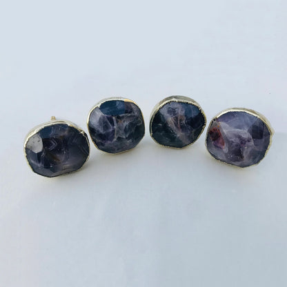 Four round faceted amethyst cabinet knobs in gilded collars