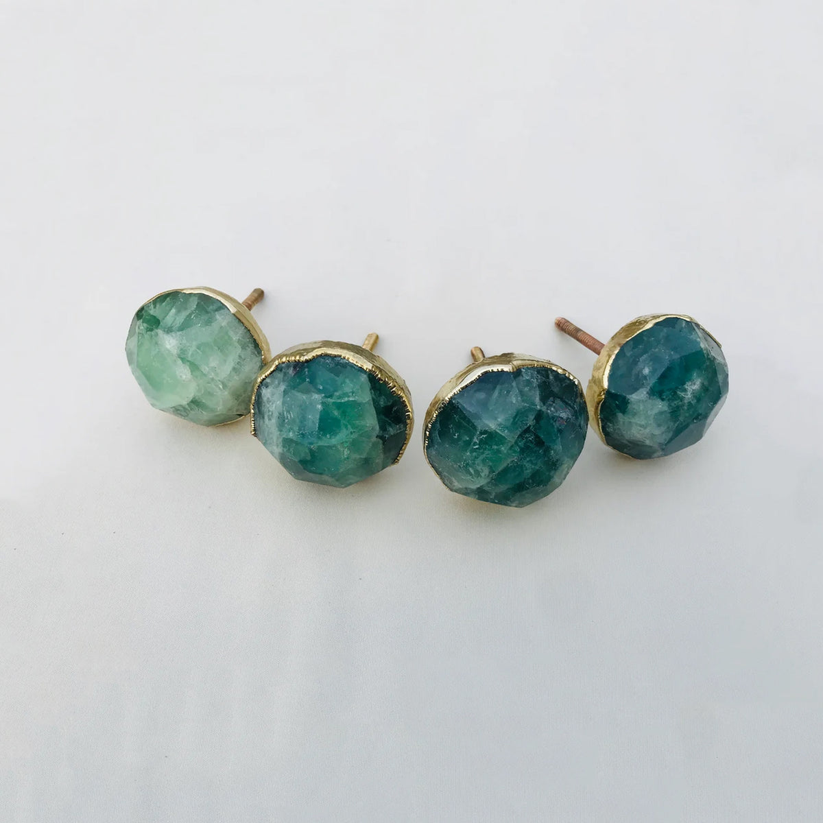 Four round faceted green fluorite cabinet knobs in gilded collars