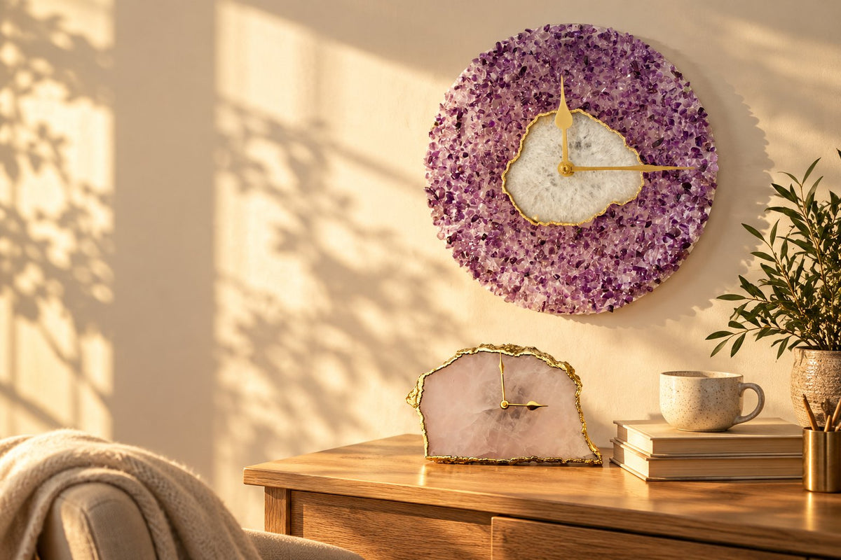 Amethyst and white agate wall clock above a rose quartz desk clock with gold hands, on a wooden dresser